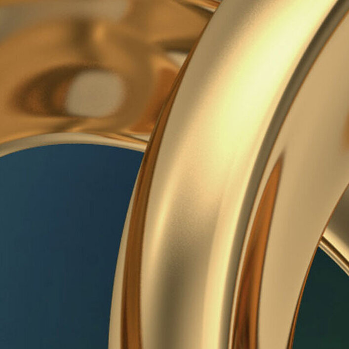 Nahaufnahme von ineinander verschlungenen goldenen Ringen mit glänzender Oberfläche auf dunklem Hintergrund.